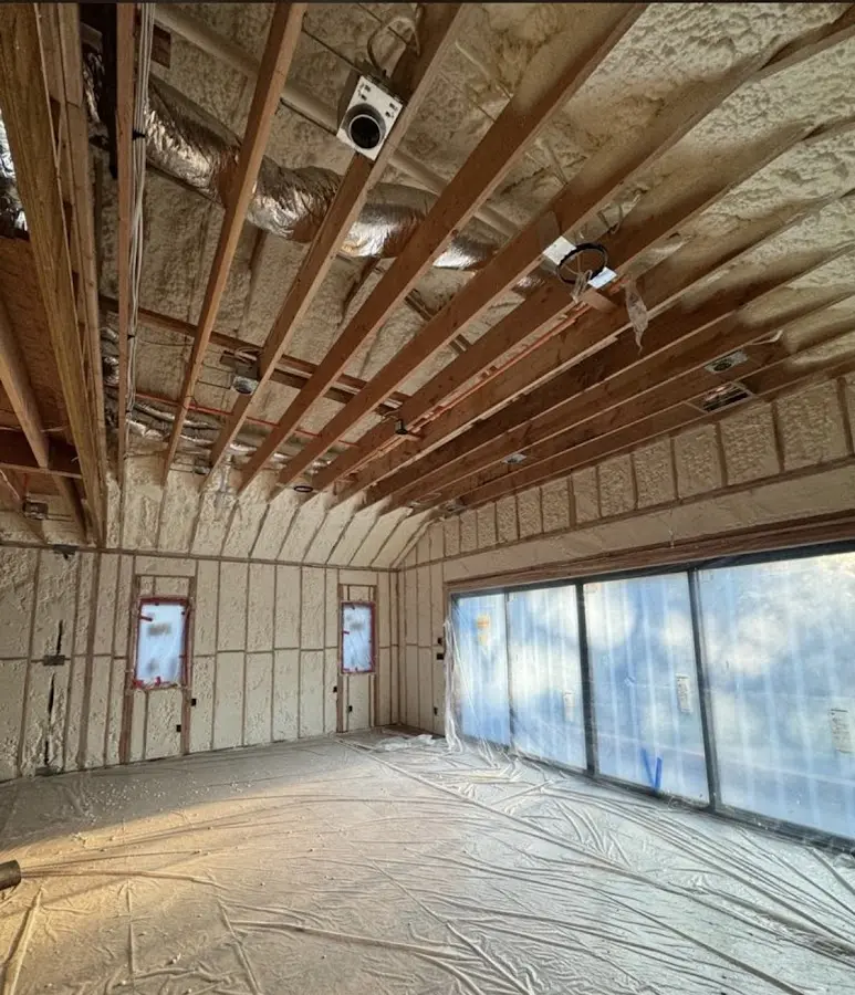 Interior walls and ceiling insulated with spray foam during new construction in Belmont